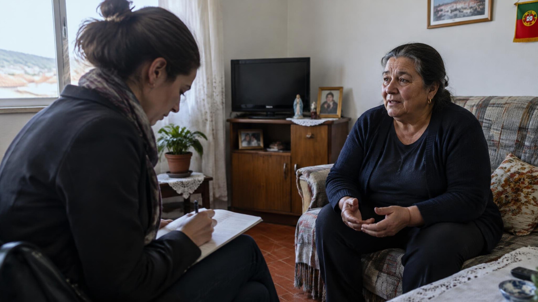 Journalist interviewing a resident with a notebook