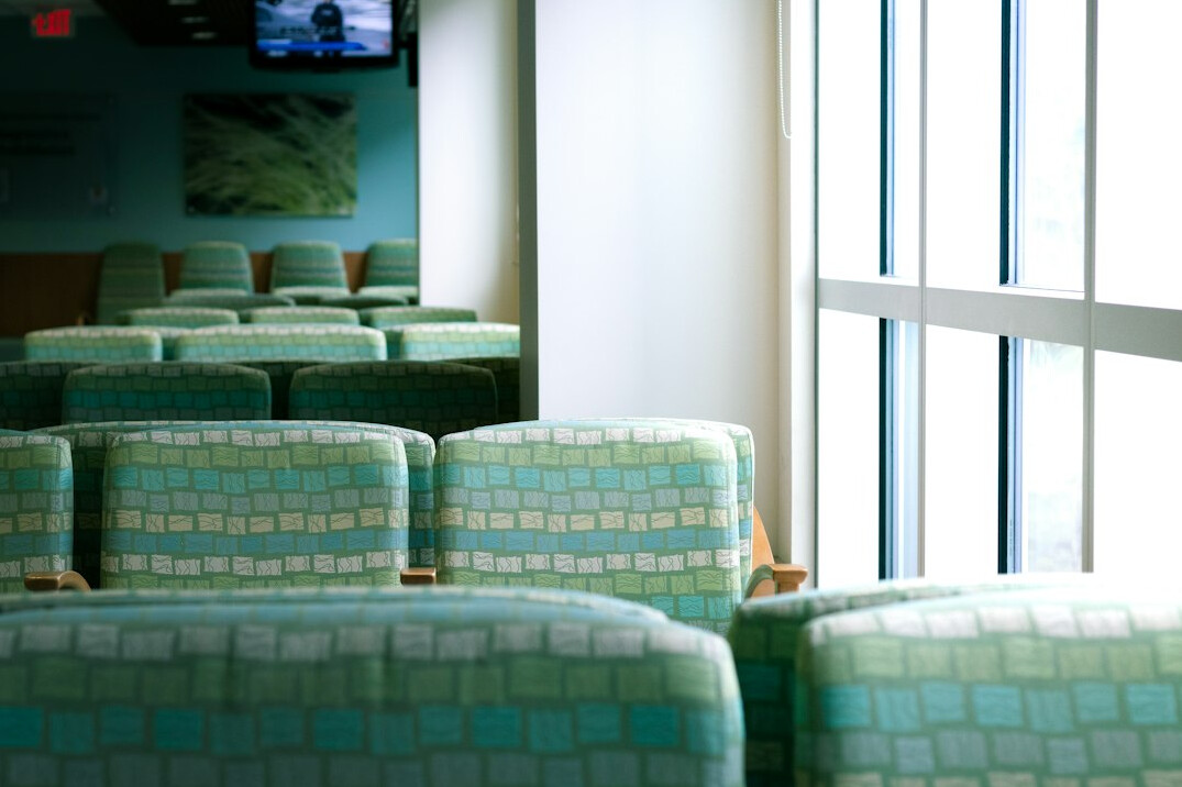 Empty hospital corridor with waiting chairs